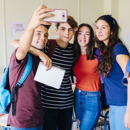 group-of-friends-taking-selfie-in-classroom group-of-friends-taking-selfie-in-classroom